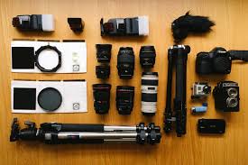 Expensive photography equipment laid out on a table including multiple camera bodies and lenses
